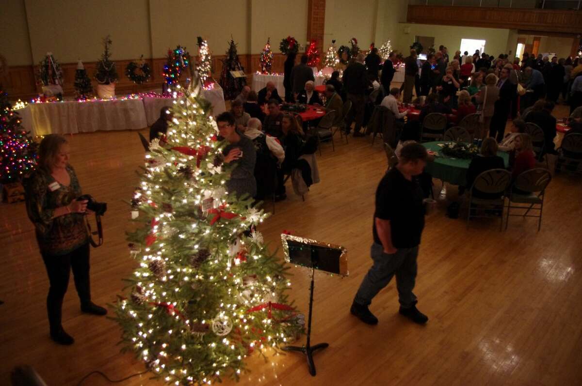 The Festival of Trees in the Ramsdell Theatre ballroom made for a festive atmosphere for the December Manistee Area Chamber of Commerce Business After Hours. (Dave Yarnell/News Advocate)