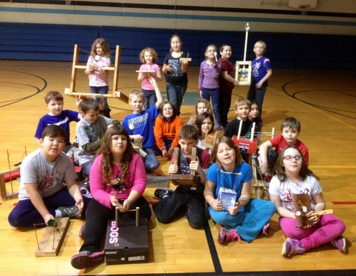 Students from Pam Tompke's third grade class at Brethren Elementary School proudly show off their marshmallow launchers they built to show how potential and kinetic energy works.