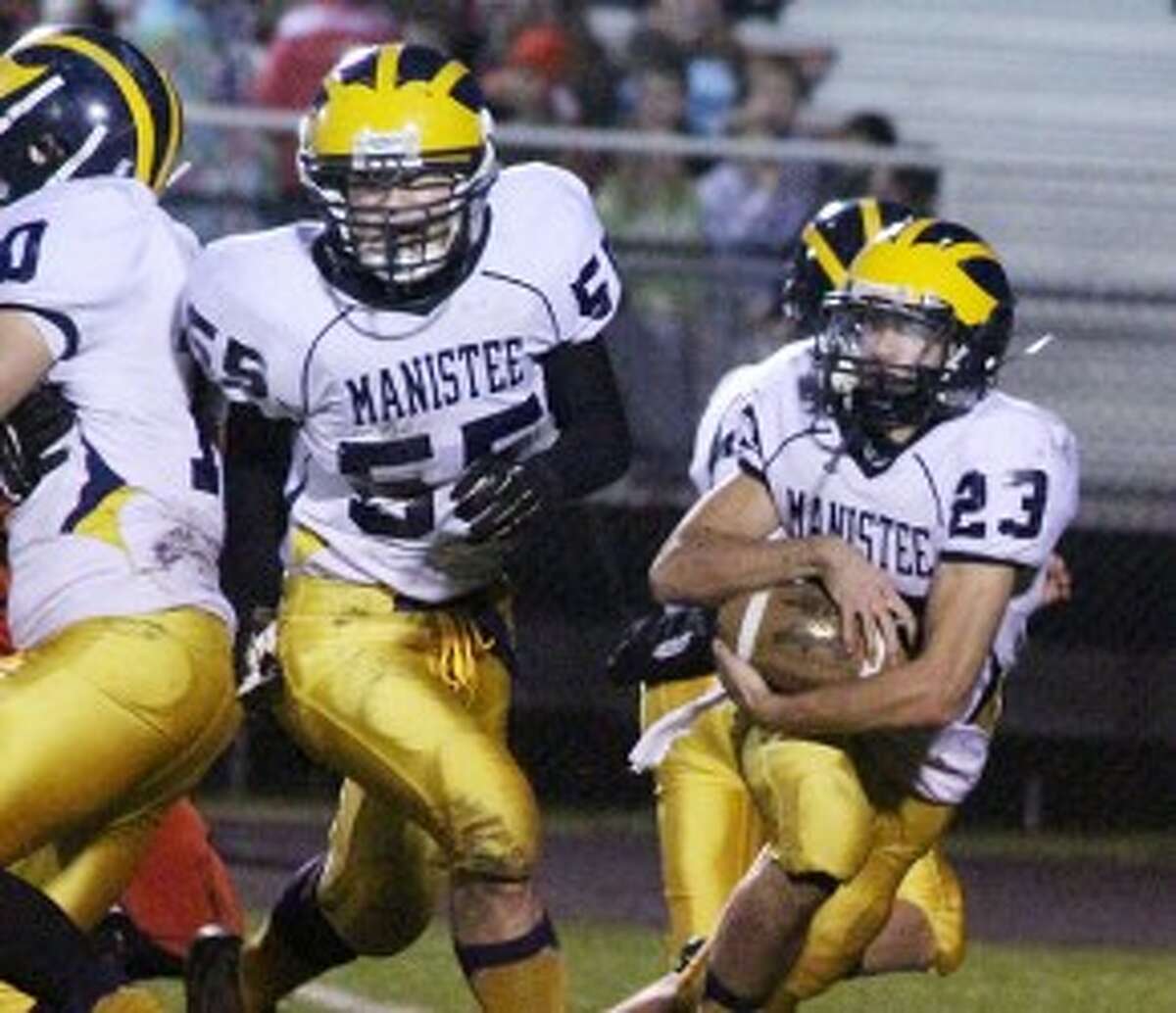 Manistee senior lineman Chris Blevins (55) looks to make a block for running back Nick Williams during a playoff loss to Reed City. Blevins was named first team Academic All-State. (Matt Wenzel/News Advocate file photo)