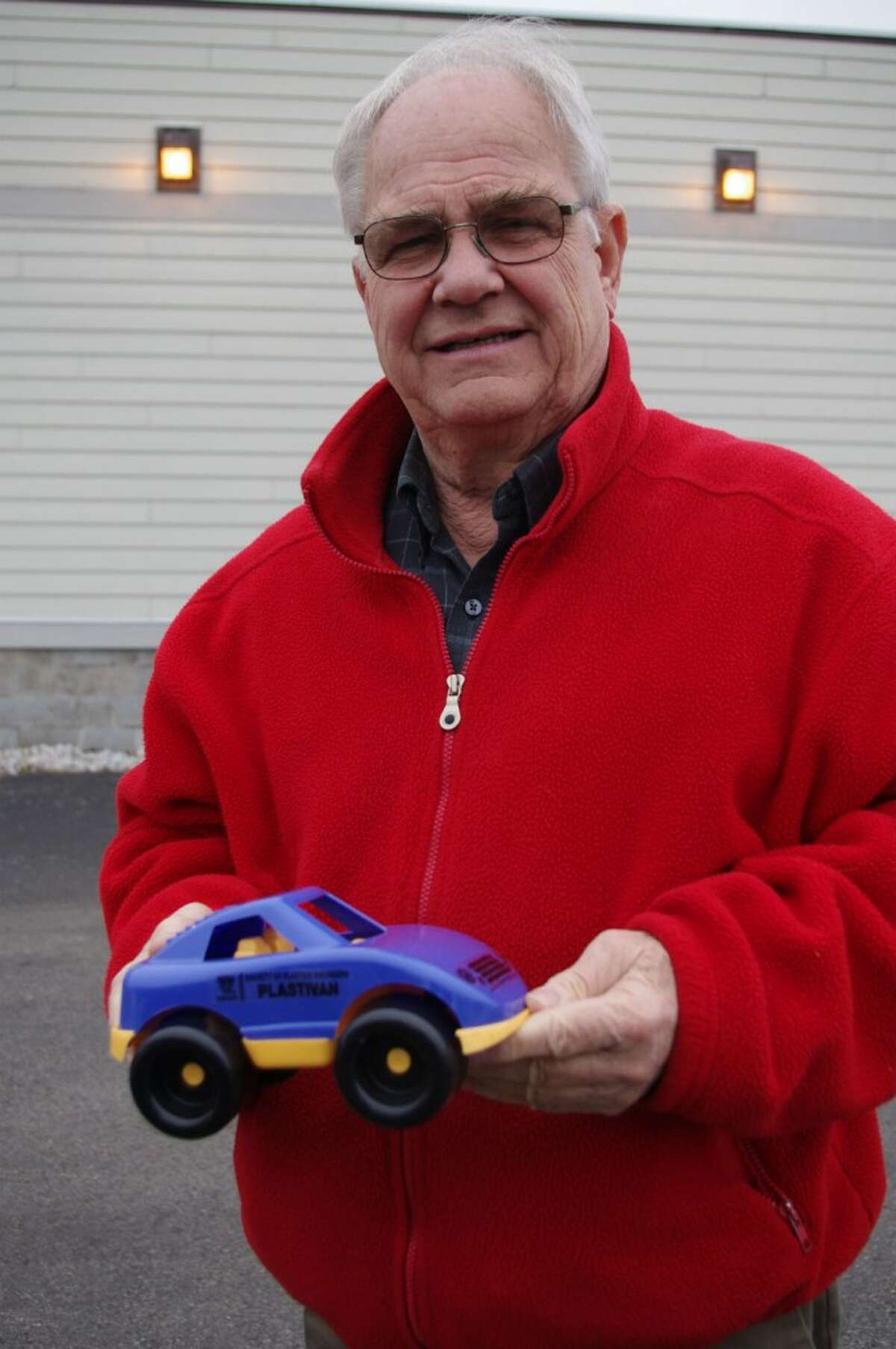 Corey Van Fleet, executive director of United Way of Manistee County, holds one of the toy trucks that will be distributed to children in the area. (Dave Yarnell/News Advocate)