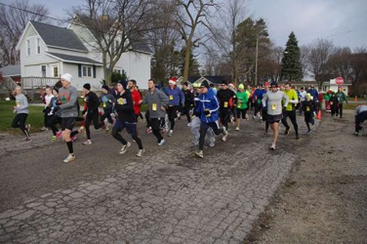 Runners take off from the starting line during Saturday’s fifth annual Jingle Bell Jog. (Dave Yarnell/News Advocate)
