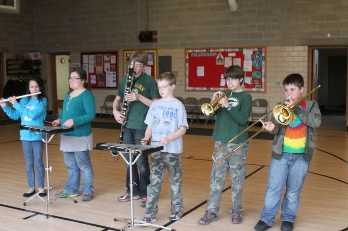 Trinity Lutheran School band students practice a musical number they will perform at the school's 33rd Annual School Fair and Expression on Saturday at the school. Music, art, writing and science skills will also be on display for the public to view at the open house celebration.
