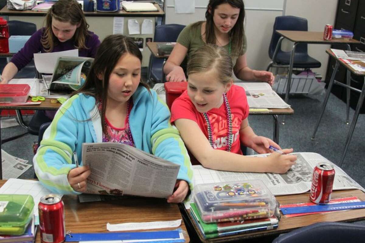 Alyssa Omar and Hallie Richardson confer over a story they are looking at as part of the Newspapers in Eduction program. Both are fourth grade students of Vivian Peck at Brethren Elementary School.