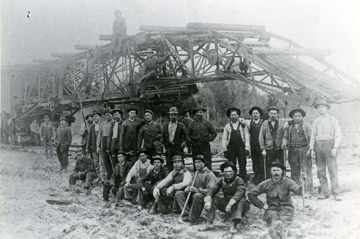 A work crew from the M&NE railroad take a break to pose for a picture in this late 1890s photograph.