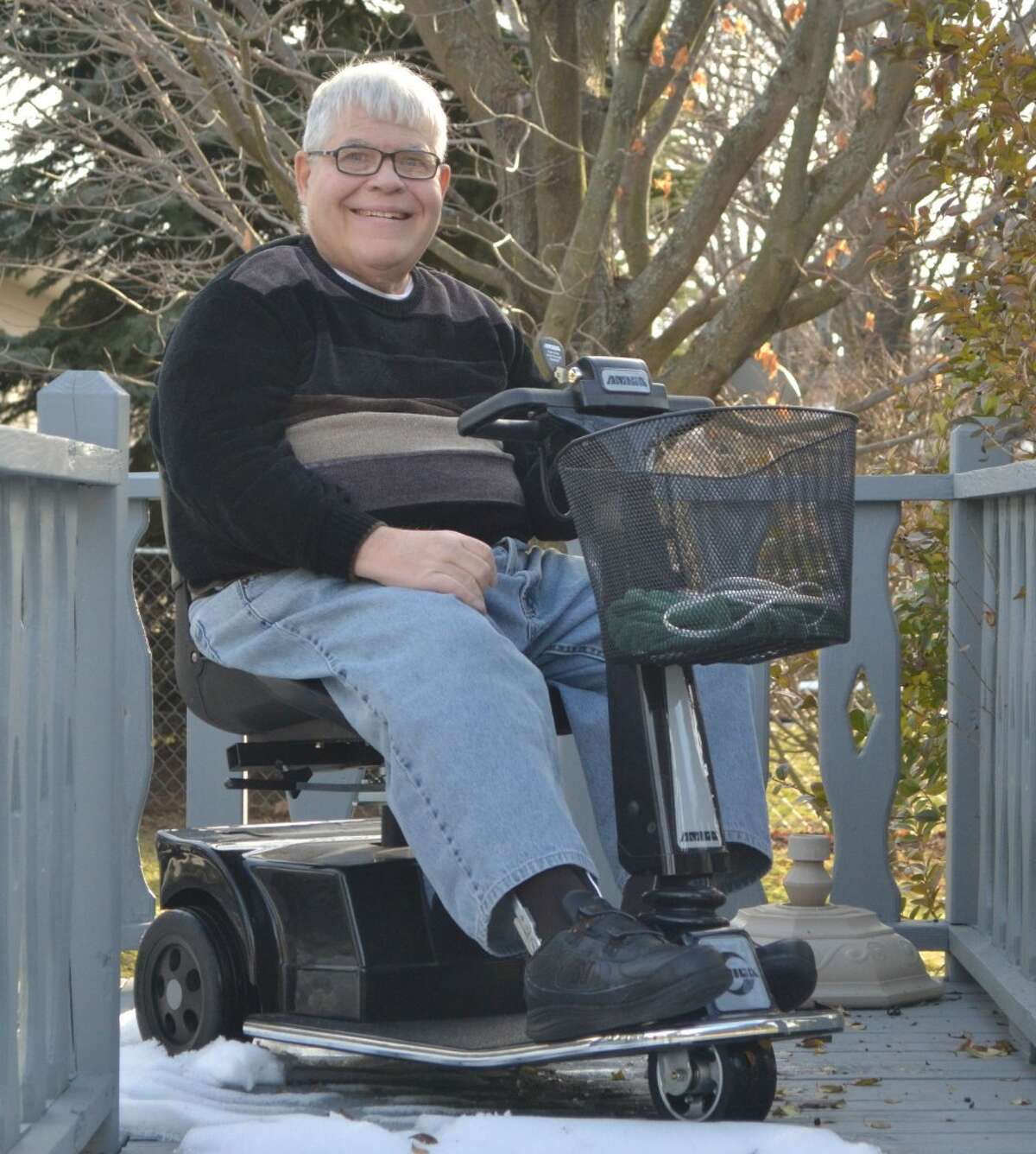 Richard Knechtges, founder and president of the Manistee County Chapter of the National Association of the Physically Handicapped (NAPH), sits on the back deck of his Manistee home. (Meg LeDuc/News Advocate)