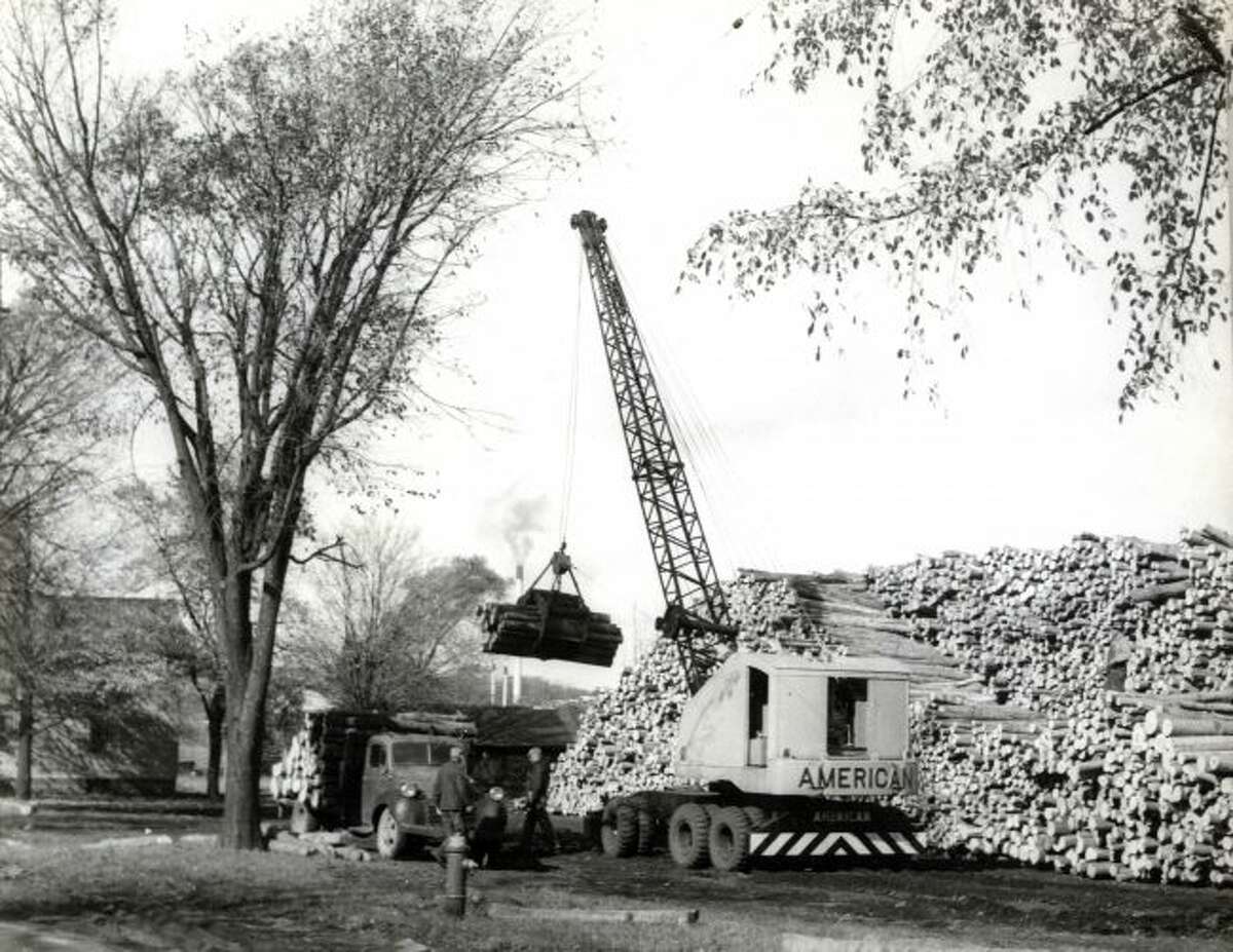 The box board company was eventually taken over by Packaging Corporation of America and this photo is photo from the early 1950s shows logs being unloaded at their Filer City location.