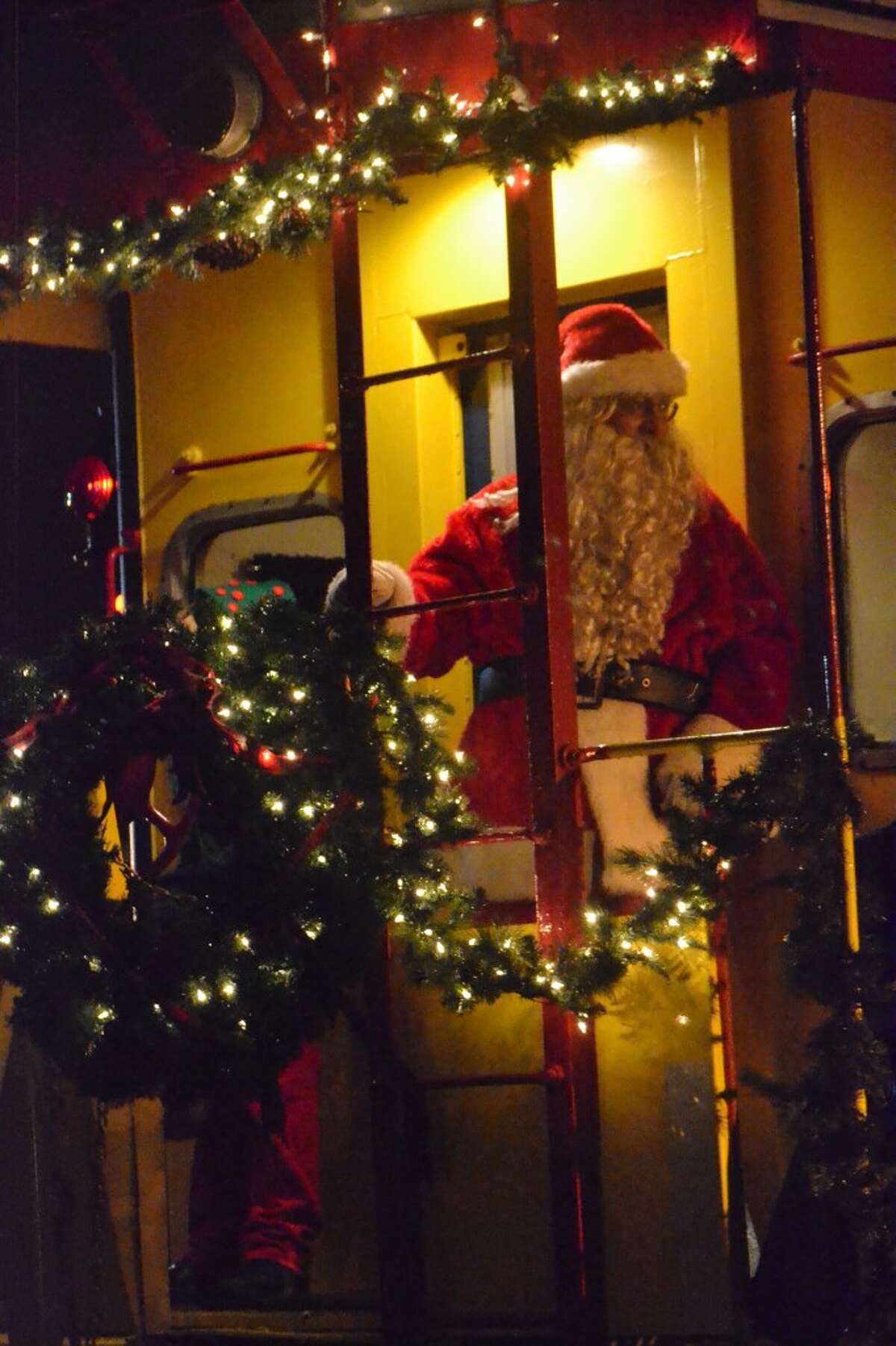 Santa prepares to disembark from the Santa Train in Manistee on Saturday night. (Meg LeDuc/News Advocate)