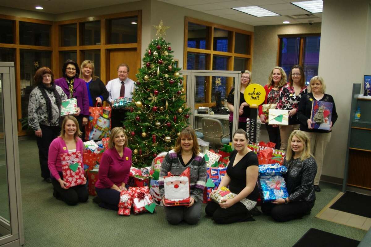 Northwestern Bank Employees and employees of Love INC gather around the Christmas tree in December 2012 at Northwestern Bank with the gifts that were purchased for the Love INC’s adopt a family for Christmas program.Bank customers and team members shopped for gifts for 100 people from 39 families. From left to right are (front row) Missy Morski, Cari Haag, Robin Paulus of Love INC, Amanda Breland, Mary Kaye Wilkosz, (standing) Chris Craycraft, Janet Duchon, Jaci Miller, Steve Brower, Caitlin Snay, Gretchen Carrick, Megan Carey and Janeen Lytle.