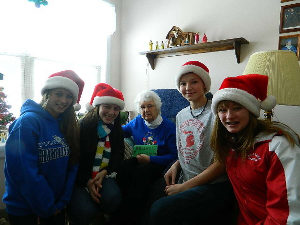 These Bear Lake Schools students surprised the Green Acres residents by bringing them all Christmas cards to celebrate the holidays. Student Katelyn Adams visits her grandmother Marge Nardone when she comes to town for Manistee County Community Foundation Youth Advisory Council meetings. Show from left to right, Breanna Fink, Katelyn Adams, Gree Acres resident Marge Nardone, Cole Verrett and McKenna Fink. (Courtesy photo)