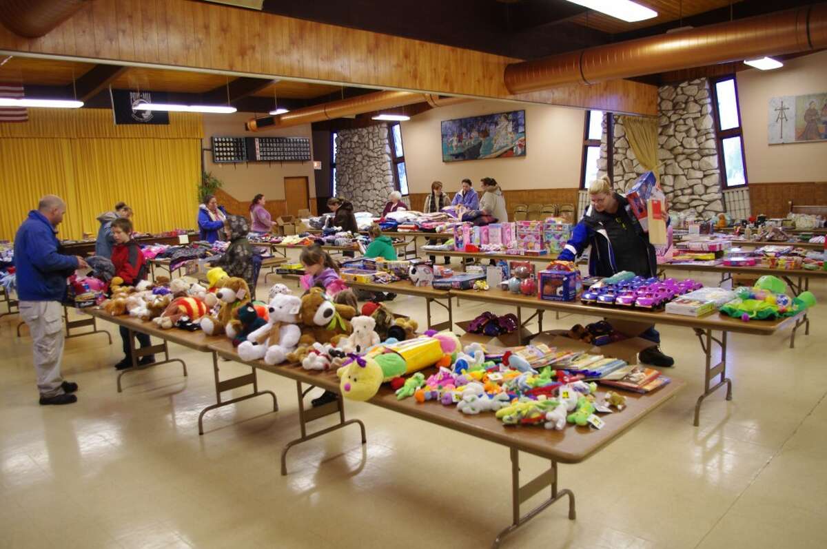 Only a few families at a time shopped for their gifts at Love INC’s annual Christmas store that was set up at St. Mary’s Church in Manistee. (Dave Yarnell/News Advocate)