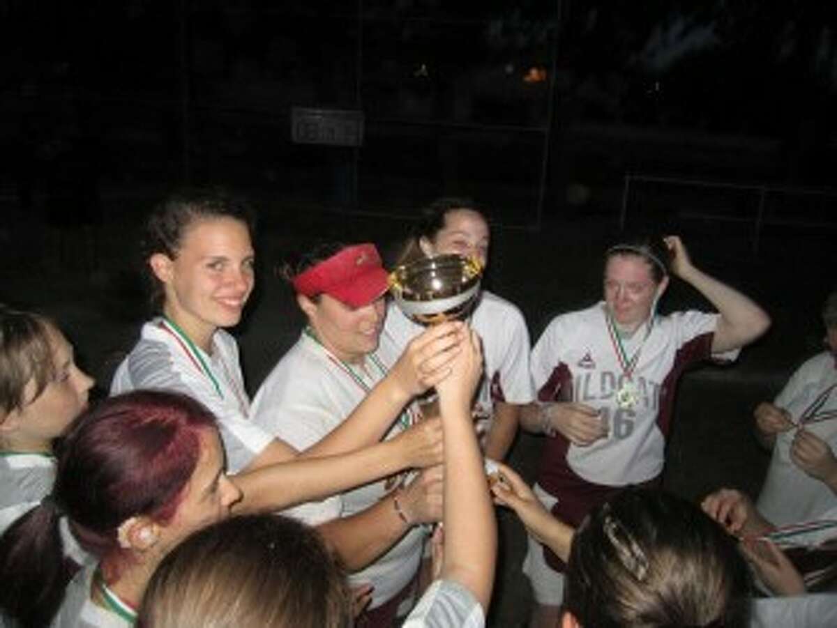 Suzanne Cole and her softball team hoist a trophy. (courtesy photo)