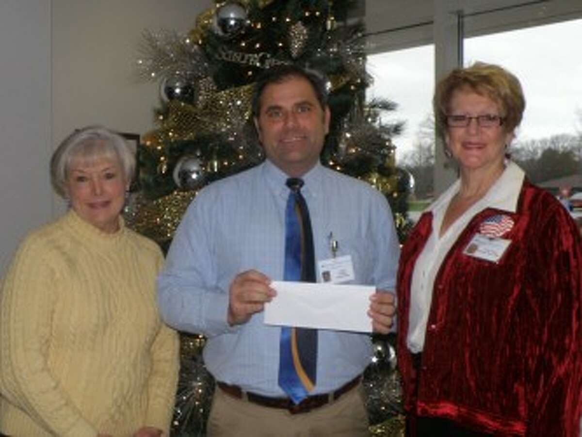West Shore Medical Center Auxiliary president Elizabeth Tyson (right) and president elect Kathleen Jeffreys (left) present West Shore Medical Center president James Barker with a check for $23,000 toward the Auxiliary’s pledge to purchase an ambulance. The recent contribution leaves only $10,000 remaining in the auxiliary’s pledge to give $152,000 to buy an ambulance. (Courtesy Photo)