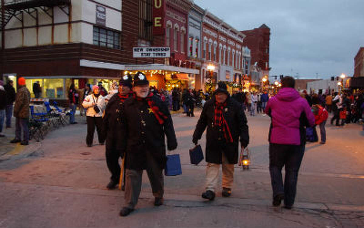 Lee Trucks (center) leads fellow Kiwanis Kops John Rowe (left) and Roger Zielinski on River Street in Manistee just before the 2010 Victorian Sleighbell Parade. (News Advocate File Photo)