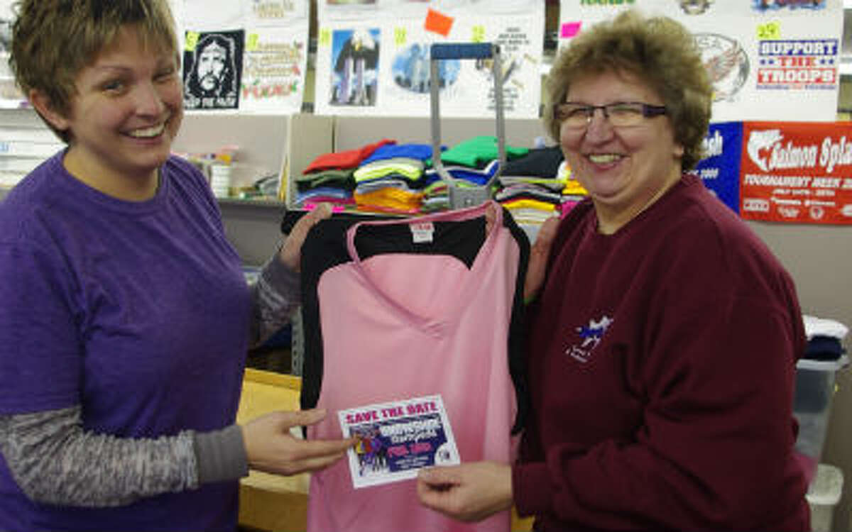 “Your name here” is what Lynne Vasquez (left) and Sharon Monnot of Sports Ink seem to saying. They will be putting the names of honored loved ones on jerseys for the Jan. 31 Manistee Catholic Central-Brethren girls basketball game to raise money for the Stomp Out Cancer Fund. (Dave Yarnell/News Advocate)