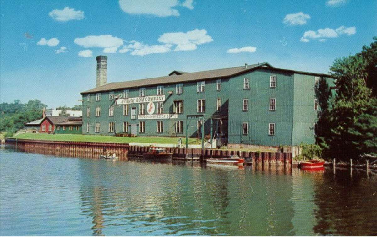 Shown is the old Century Boat building factory that was located along the Manistee River Channel. The Century Terrace building presently occupies that location.