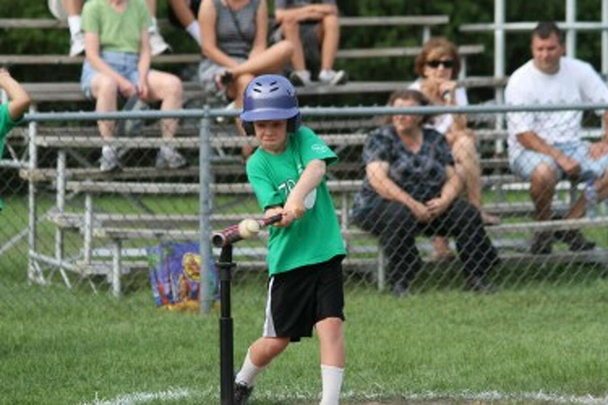 Ben Schlaff connects for a line drive during a Manistee Recreation Association T-ball game last week held at Mack Park. (Dylan Savela/News Advocate)