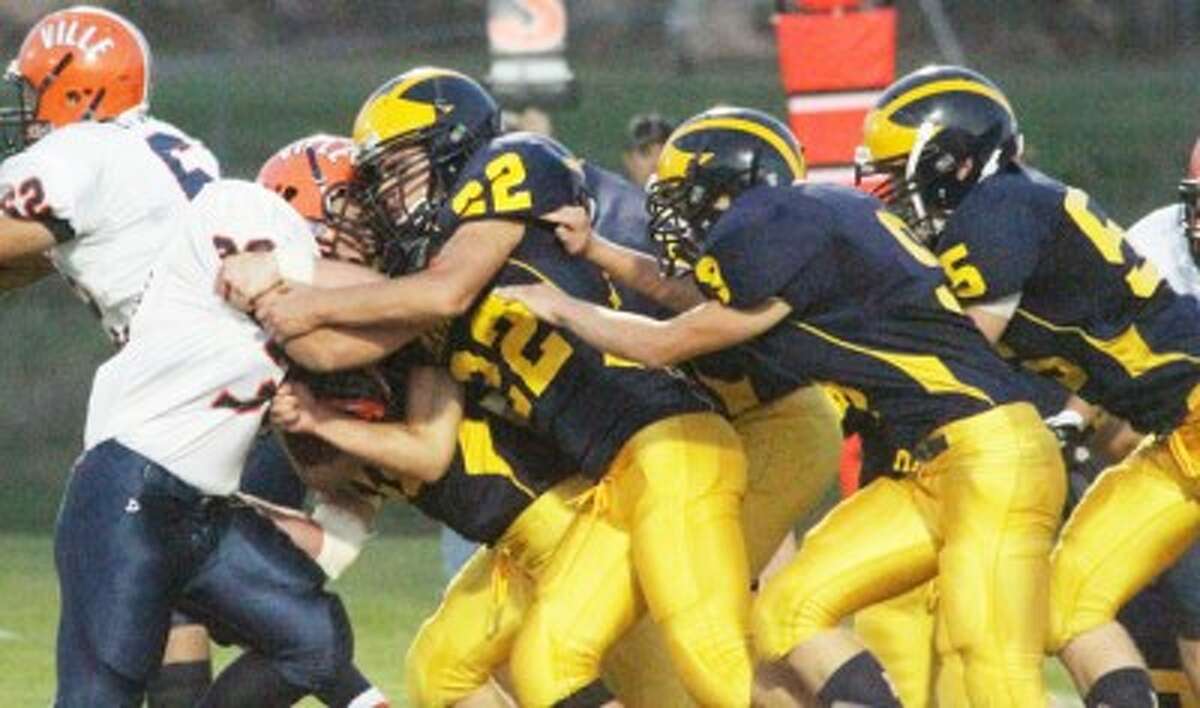 Senior Jared Knapp (22) leads a group of Manistee tacklers during last week’s win against Wyoming Kelloggsville. The Chippewas will host Standish-Sterling tonight with a shot at three straight wins. (Matt Wenzel/News Advocate)