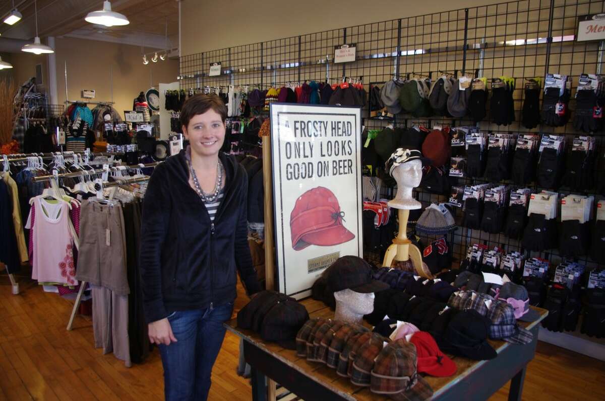 Carrie Mosher at The Outpost in downtown Manistee said she is looking forward to a good Christmas shopping season. The store stocks many made in Michigan items, such as Stormy Kromer caps that are made in the Upper Peninsula. (Dave Yarnell/News Advocate)
