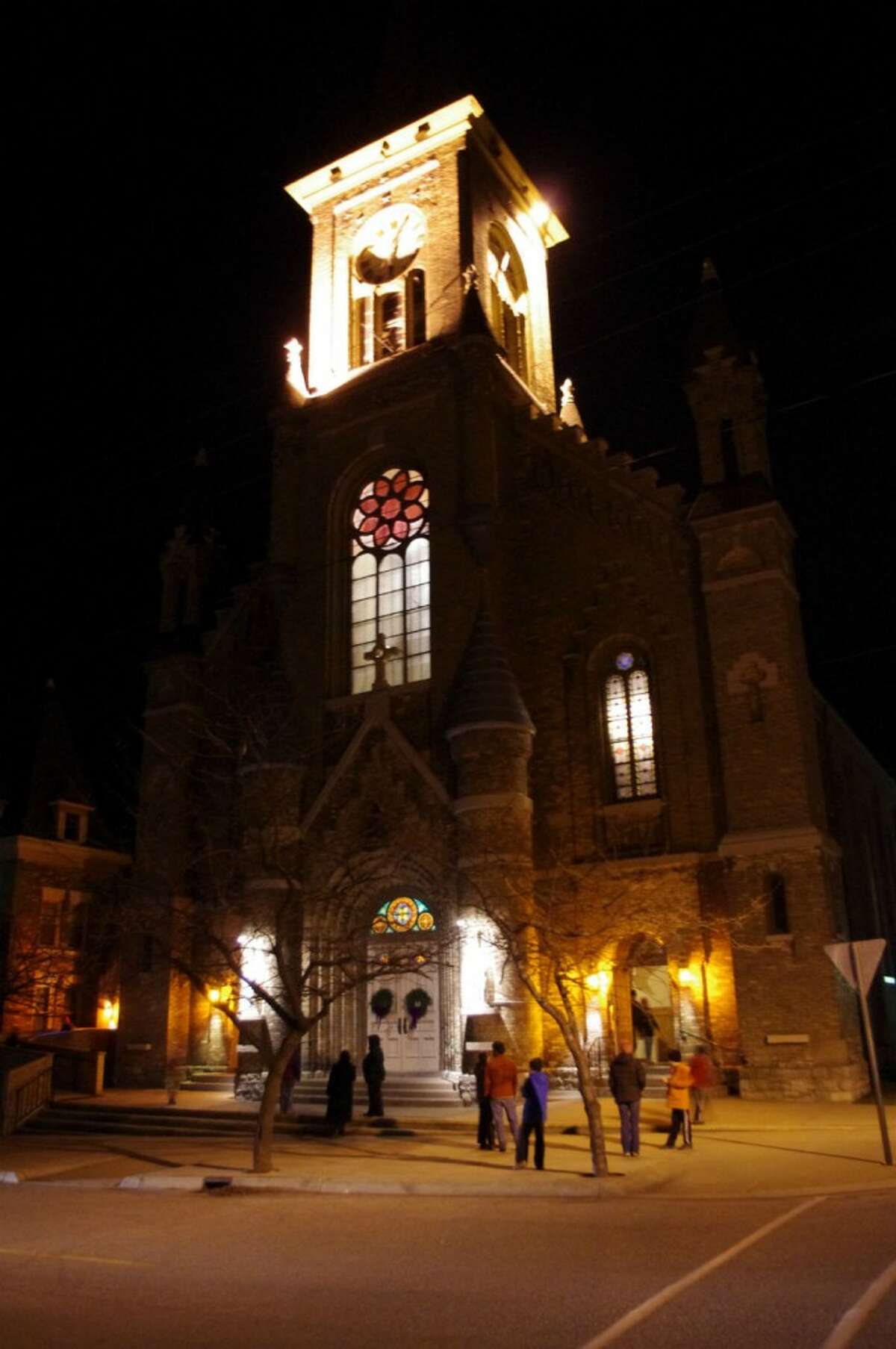 Many people listened to the bell tower concert from their cars, some from inside the church, and a few stood on the front steps of Guardian Angels Church to here the Christmas songs. (Dave Yarnell/News Advocate)