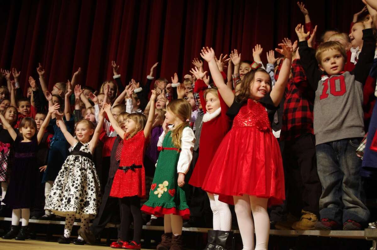 Kindergarten students act out the song “There was a Pig went out to Dig.” (Dave Yarnell/News Advocate)