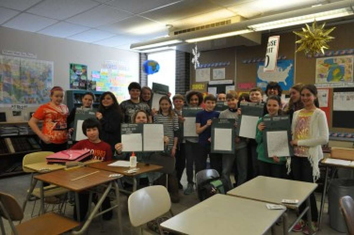 Stephanie Oden’s class poses with their complete assignments.