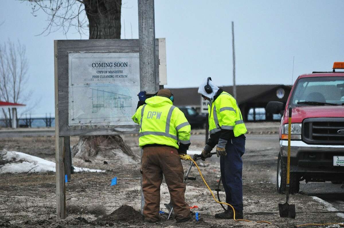 Manistee DPW crew members use the city’s vactor truck to clean the fish cleaning station’s utility lines.