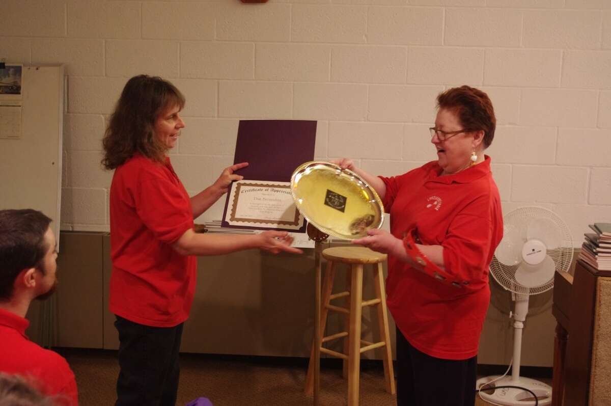 Nancy Supran (left), executive director of the Circle Rocking S Children’s Farm, honors Pam Bresnahan for her many years of service with the organization’s Music Therapy Children’s Farm Choir. (Dave Yarnell/News Advocate)