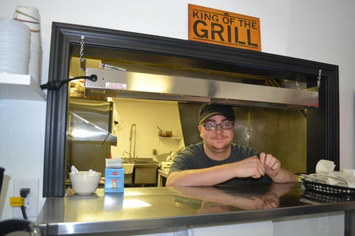 Cook Josh Pifer is one of John and Michelle Blackman’s 10 employees at the M-22 Grill, which opened for business Thursday. (Meg LeDuc/News Advocate)