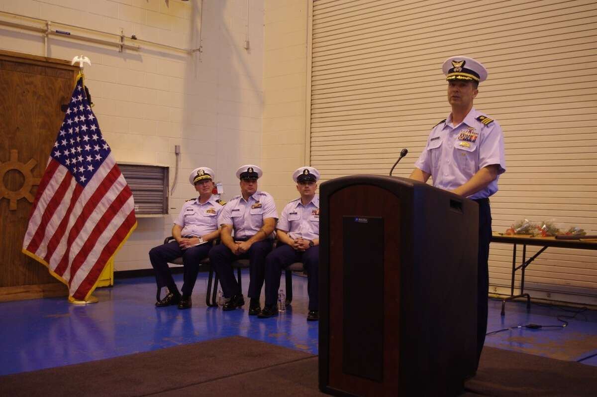 U.S. Coast Guard Commander Erik A. Leuenberger speaks during the change of command ceremony Friday at Coast Guard Station Manistee. Behind him are (from left to right) Commander Jeffrey S. Plummer of the U.S. Navy, Andrew J. Gyurscik, the new chief of Station Manistee, and John Tribfelner, former chief of the Station Manistee who has been reassigned to Charlevoix. (Dave Yarnell/Staff Writer)