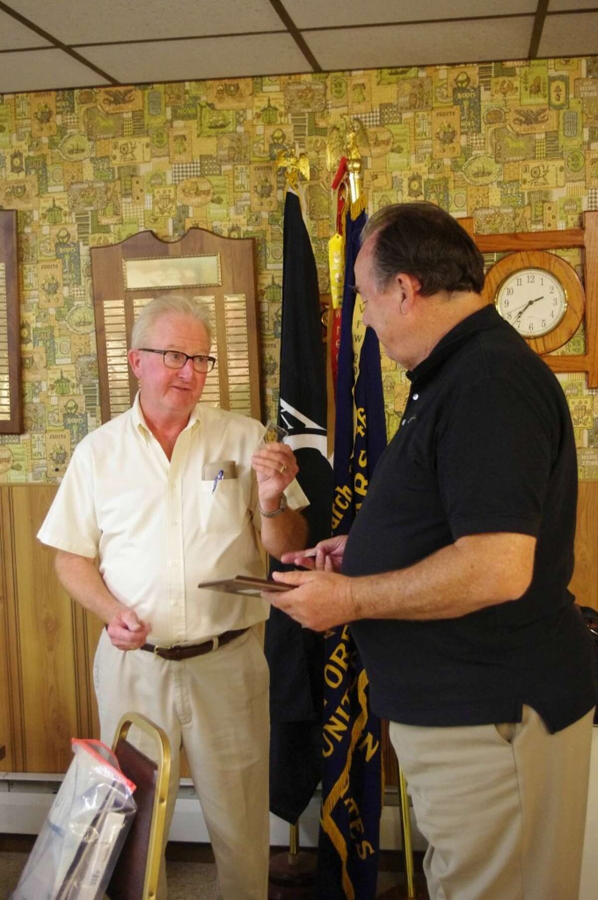 Last week, when he spoke to the United Veterans Council of Manistee County, Jack Beattie (left), a survivor of the 1967 attack on the U.S.S. Liberty, presented a plaque to Ted Arens from the Liberty Veterans Association. Arens was named an honorary crewman of the ship and praised for his "unselfish and exemplary actions in the pursuit of exposing the true story of the June 8, 1967 attack." (Dave Yarnell/News Advocate)
