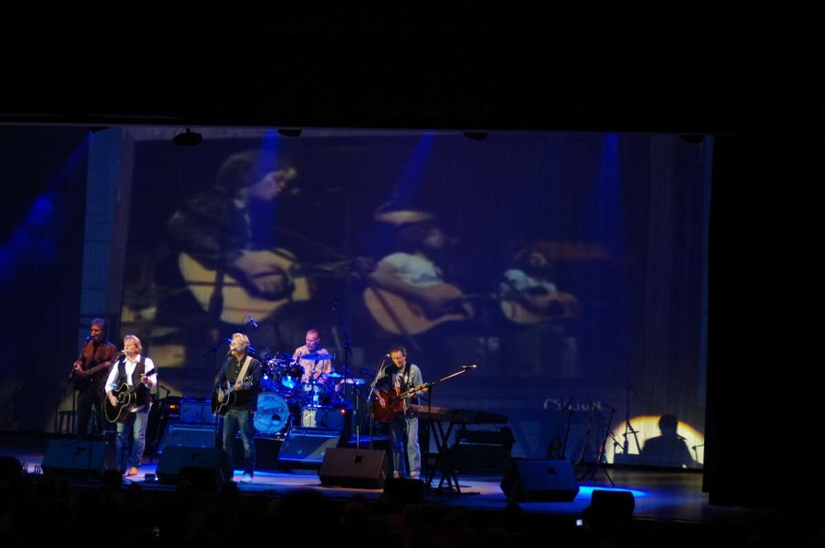 The 1970s rock group America played in front of a vision of themselves from the past as they sang one of their hits, "Ventura Highway," on Saturday at the Little River Casino Resort. (Dave Yarnell/News Advocate)