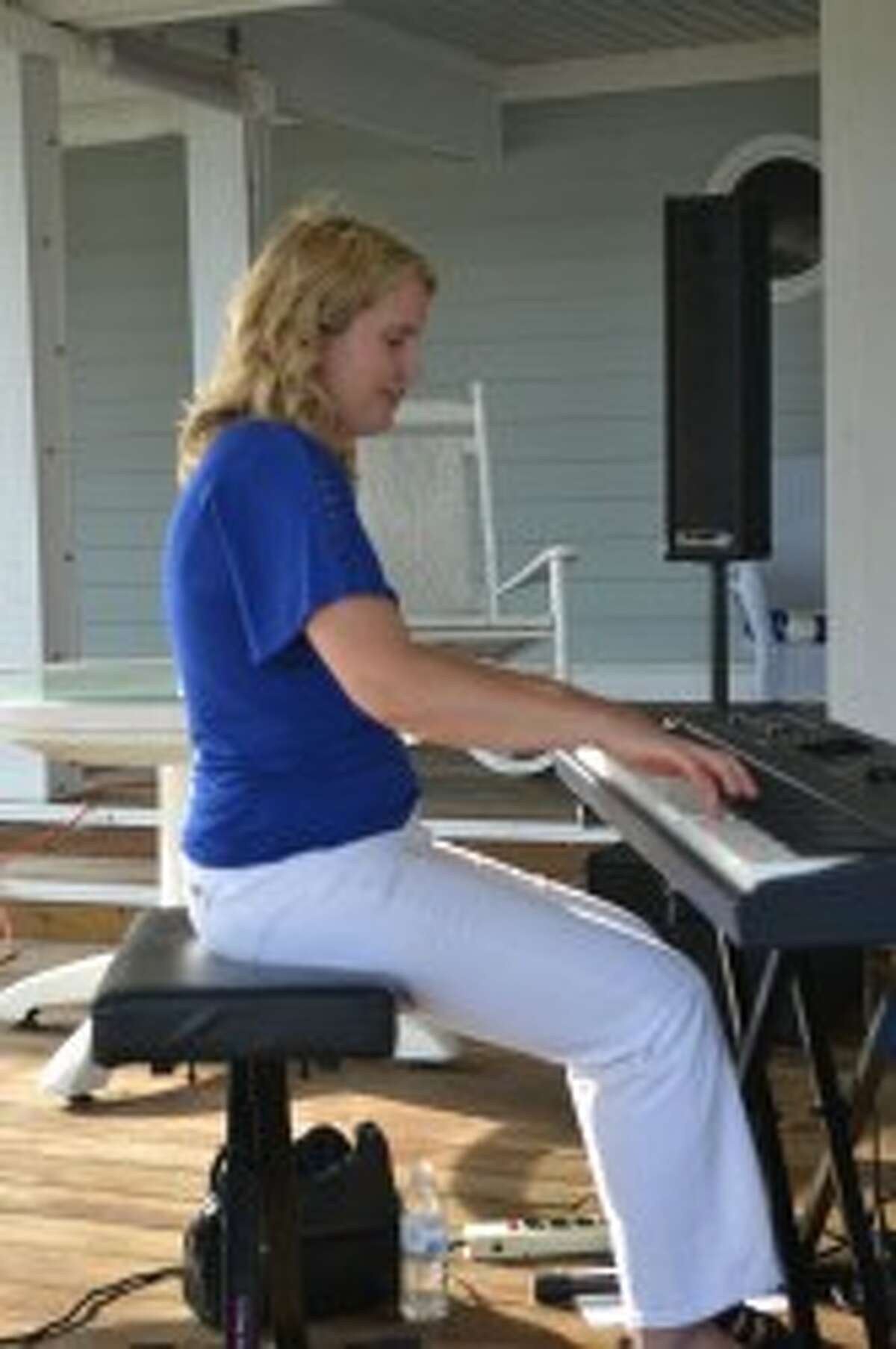 Carrie Selbee, of Manistee, entertains guests on the piano at a Manistee Community Kitchen fundraiser at Seng's Marina on Saturday. (Meg LeDuc/News Advocate)