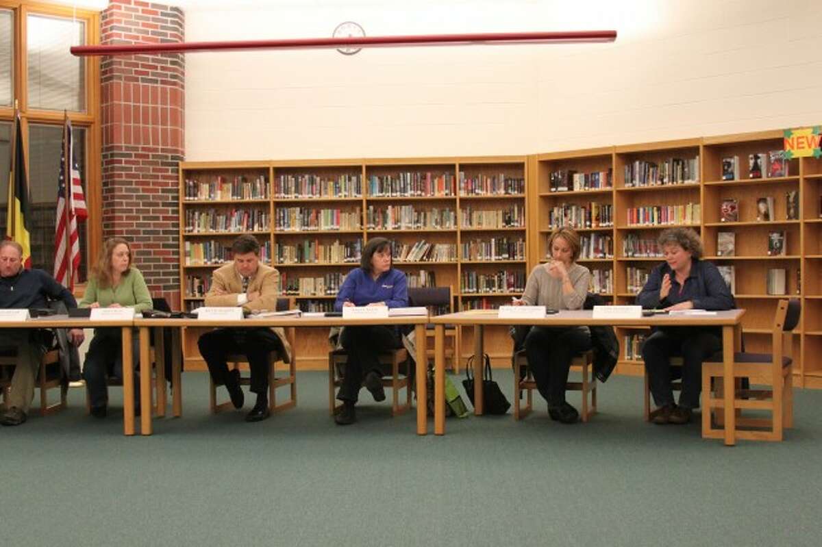 Onekama Consolidated Board of Education members listen to a presentation.