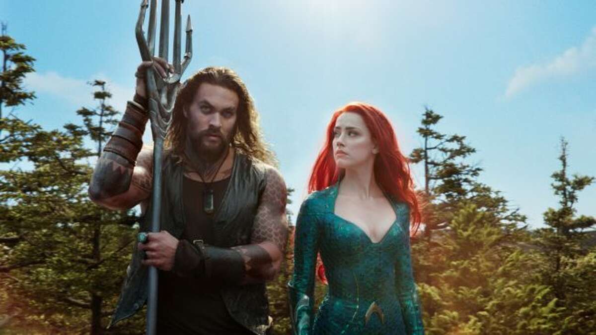 This image released by Warner Bros. Pictures shows Jason Momoa, left, and Amber Heard in a scene from "Aquaman." (Warner Bros. Pictures via AP)
