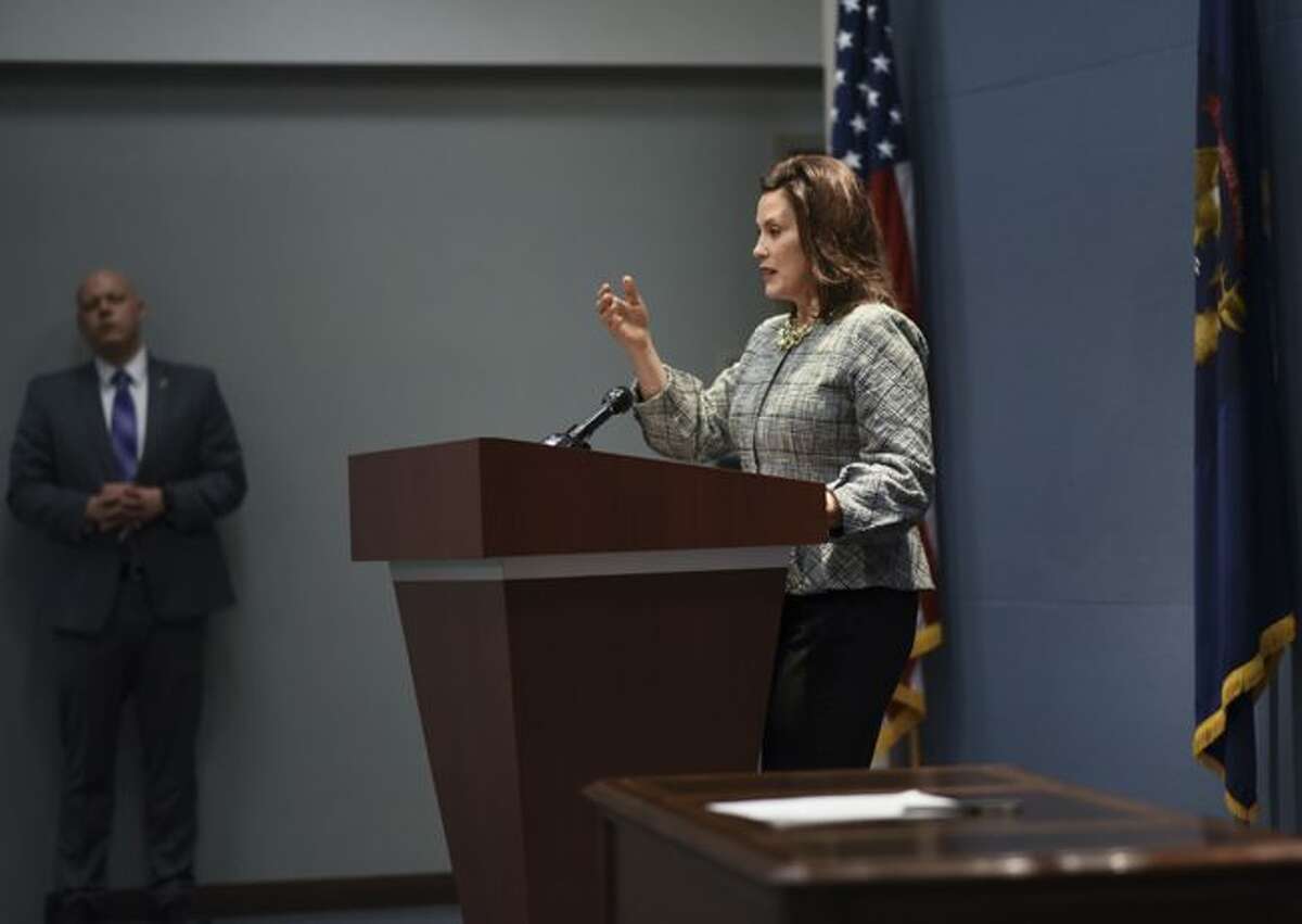 Michigan Gov. Gretchen Whitmer speaks Wednesday, Jan. 2, 2019, at the Romney Building in downtown Lansing, Mich. Whitmer is directing state employees to immediately report all "imminent" threats to public health, safety or welfare higher up the chain. The Democrat issued her first executive directive Wednesday, a day after taking office. (Matthew Dae Smith/Lansing State Journal via AP)