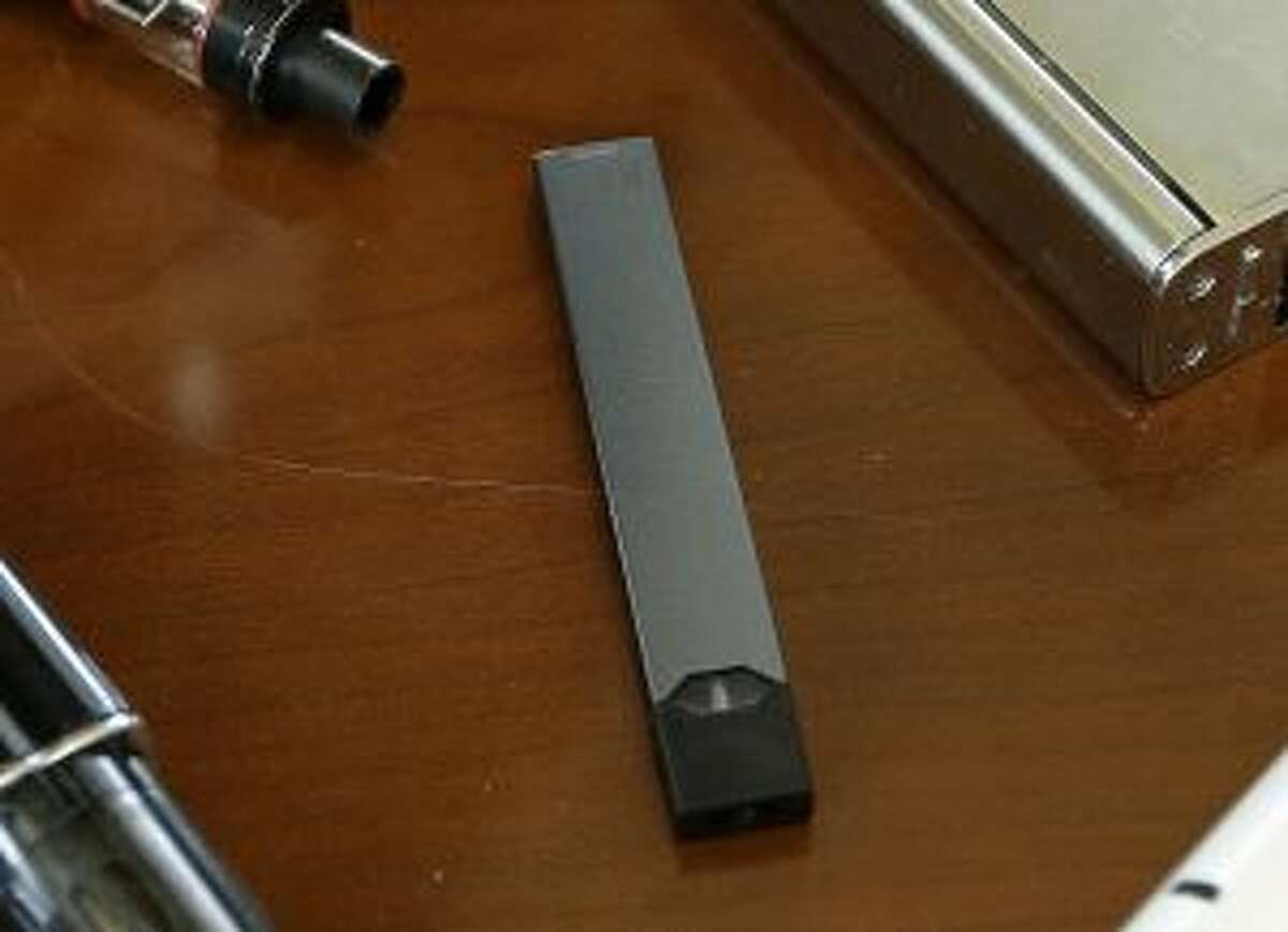 FILE - This April 10, 2018, file photo shows a Juul in Marshfield, Mass. Altria is spending $12.8 billion for a stake in e-vapor company JUUL as one of the world’s biggest tobacco companies tries to offset declining cigarette use. (AP Photo/Steven Senne, File)