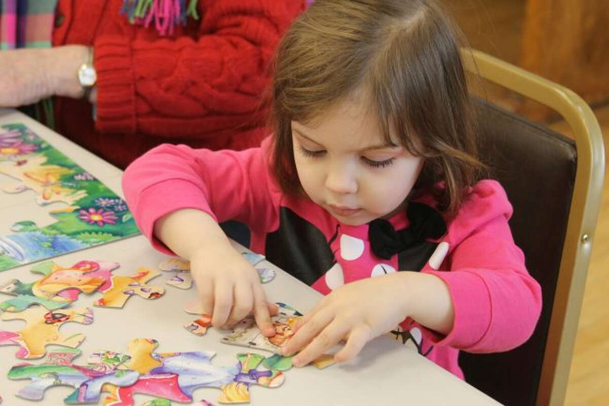 Children could put together puzzles on Saturday at Manistee Library's Puzzle Day event. (Michelle Graves/News Advocate)