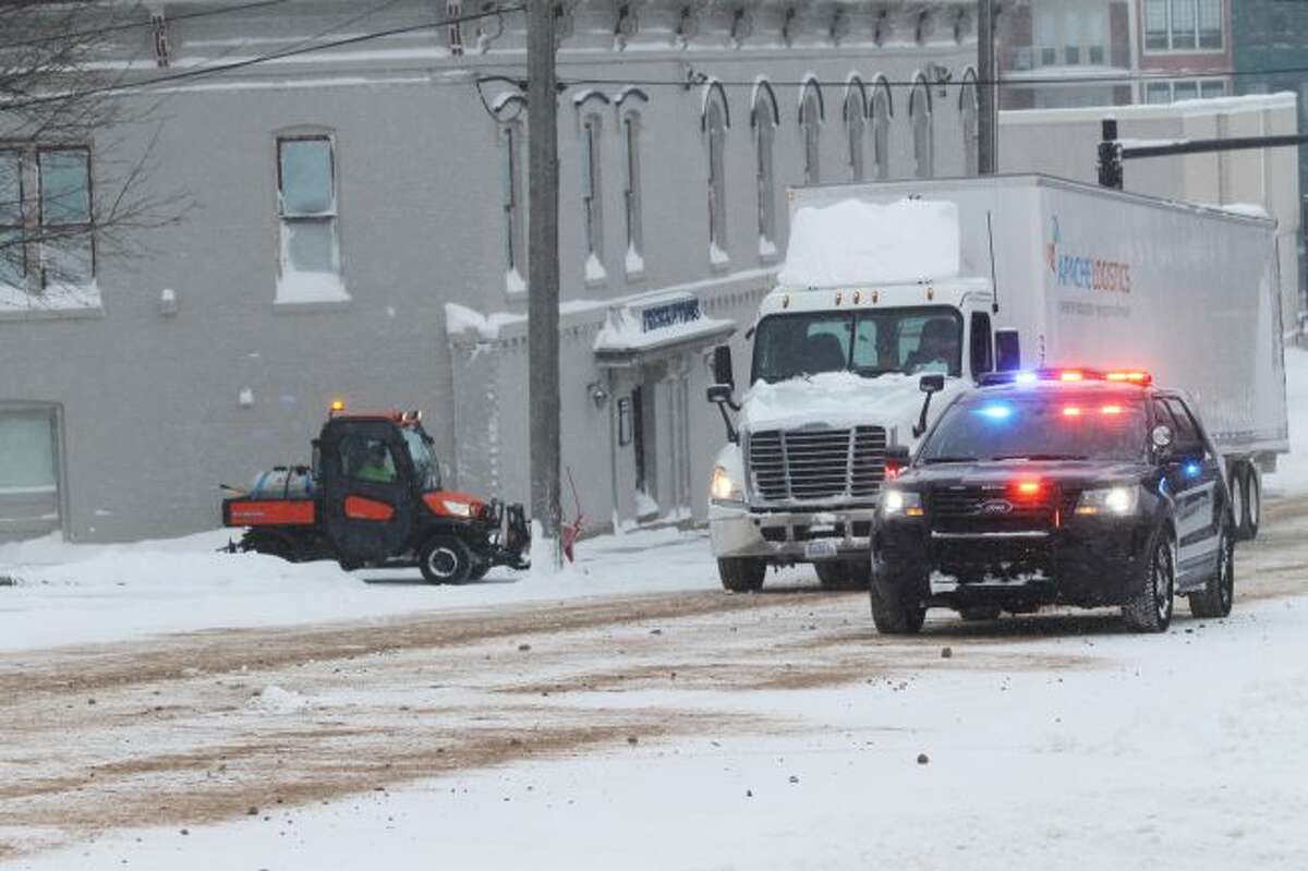 Police officers block off a portion of River and Maple streets while they assisted a semi-truck driver on Thursday morning. (Ashlyn Korienek/News Advocate)