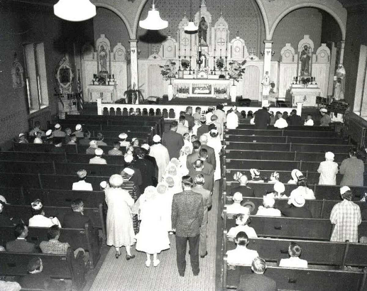 Children make their First Communion at the former St. Mary’s Church formerly located off of Third Street near Sycamore Street.