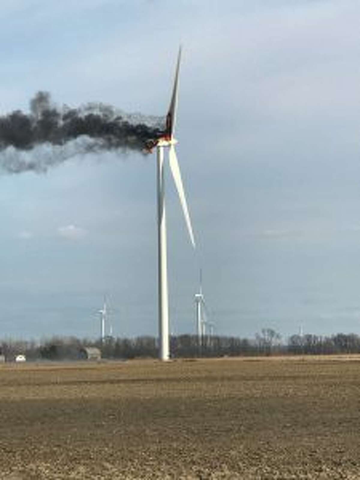 A fire burns at a wind turbine on Monday, April 1, 2019, near Elkton, Mich. The fire drew spectators who watched flaming debris fall to the ground, but no injuries were reported. Crews let the fire burn itself out. (Renee Willis/The Huron Daily Tribune via AP)