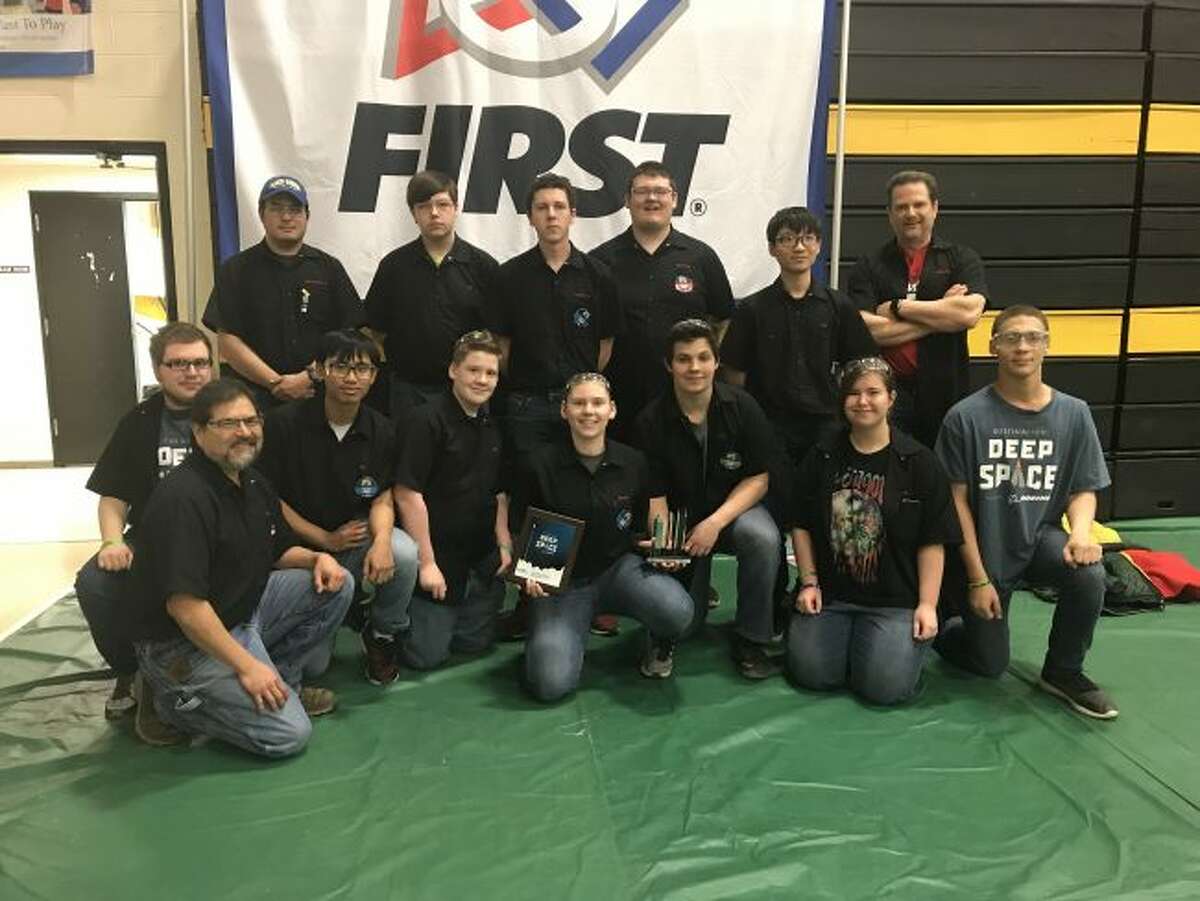The Bear Lake Robotics team proudly pose with the trophy and plaque they received from their third place finish at the Traverse City District Robotics Tournament. Shown kneeling (left to right) are Kevin Groll, Steve Gomez (mentor), Thanh Nhan Nguyen (exchange student), Bryce Travy, Alyssa Eisenlohr, John Evans, Megan Gydesen and TJ Freeman. Back row (left to right) are Chris Gomez (mentor), Edward Fairchild, Trevor Eisenlohr, Curtis Kennedy, Noppawat Thitisublert (exchange student) and John Prokes (coach).
