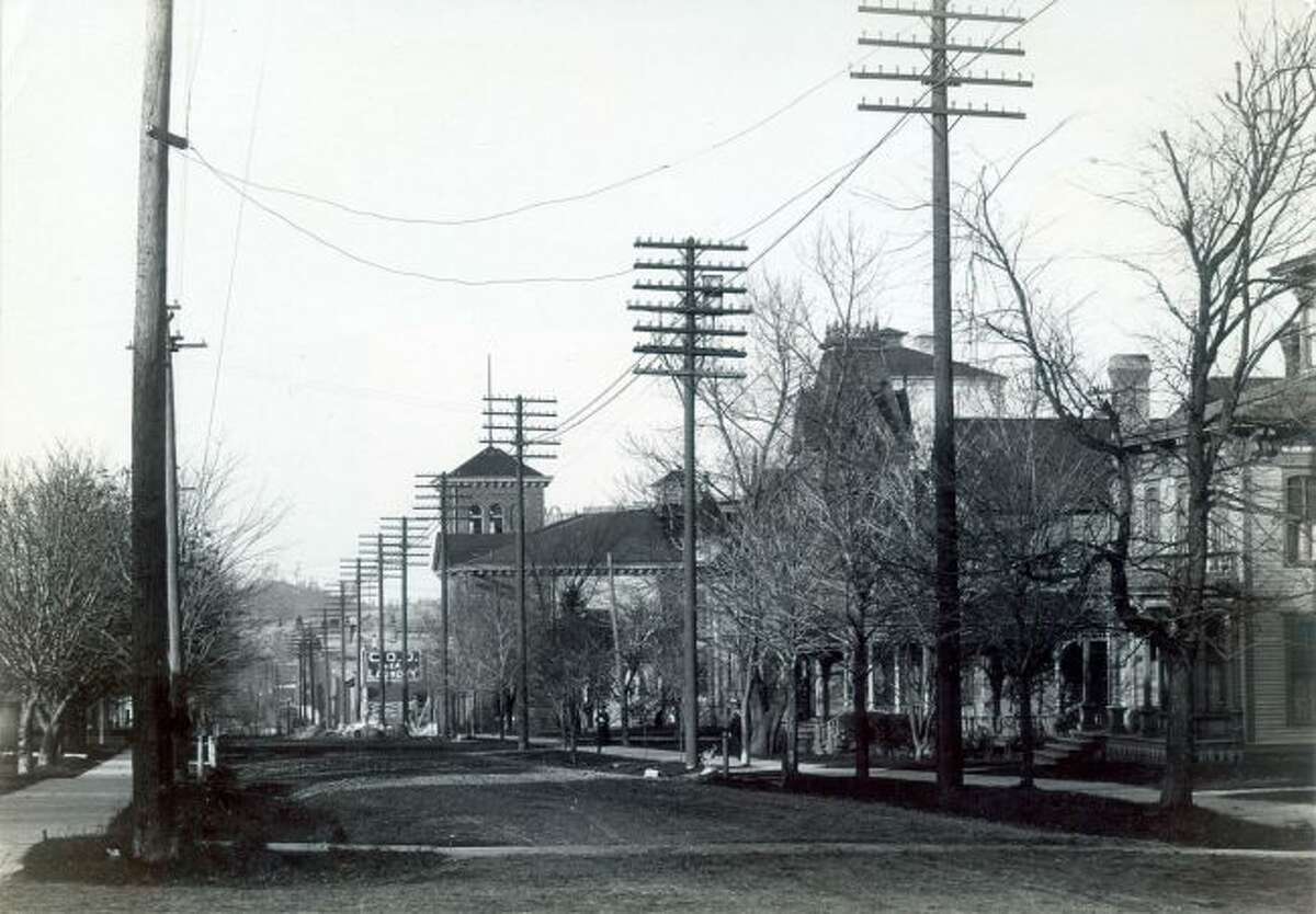 This 1905 photograph taken from the corner of the Third and Maple streets near the current location of the Manistee Courthouse building shows how the streets were not even paved at that time.