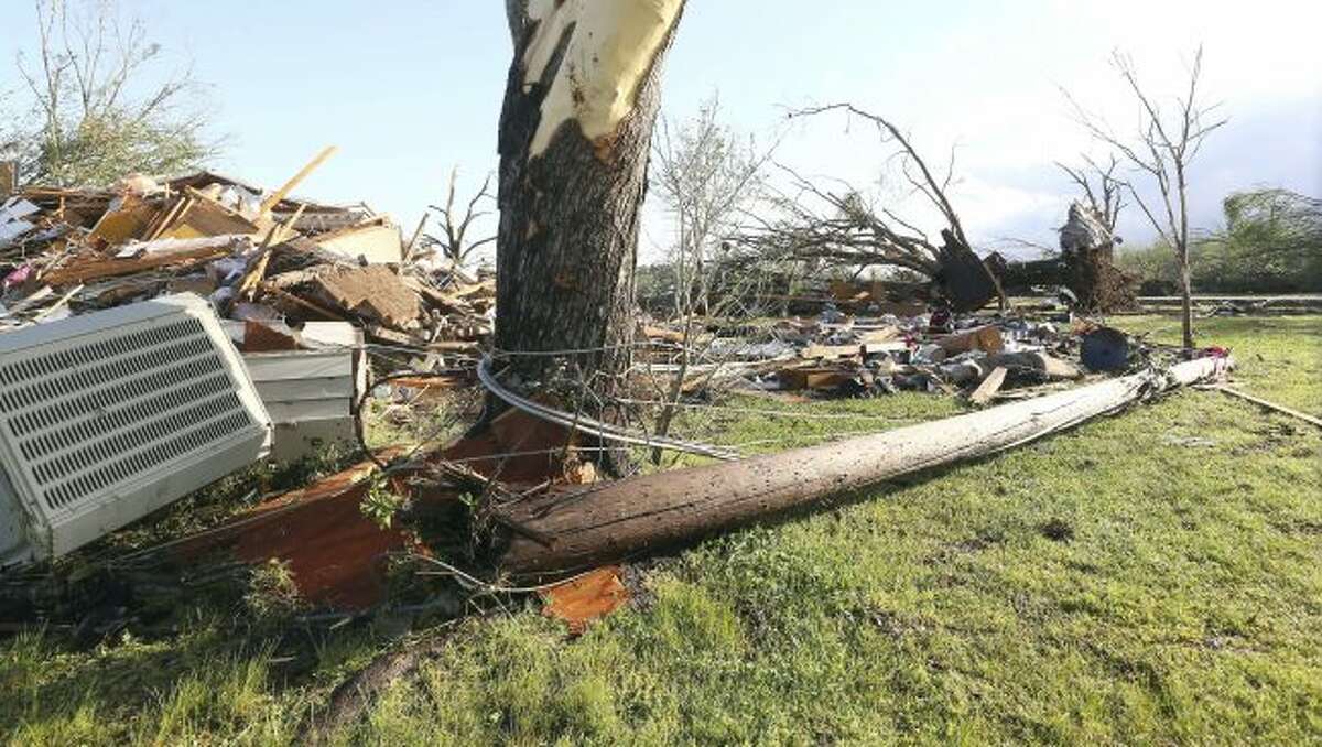 In this image made with a wide angle lens, debris is littered on the ground where a home once stood in Hamilton, Miss., after a deadly storm moved through the area Sunday, April 14, 2019. (AP Photo/Jim Lytle)
