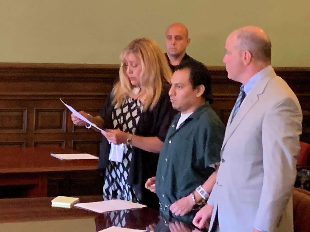 Magdaleno Perez Calixto, center, stands between an interpreter and his lawyer, as he prepares to be sentenced Tuesday for kidnapping and burglary charges connected to the October 2016 death of a man in Troy.