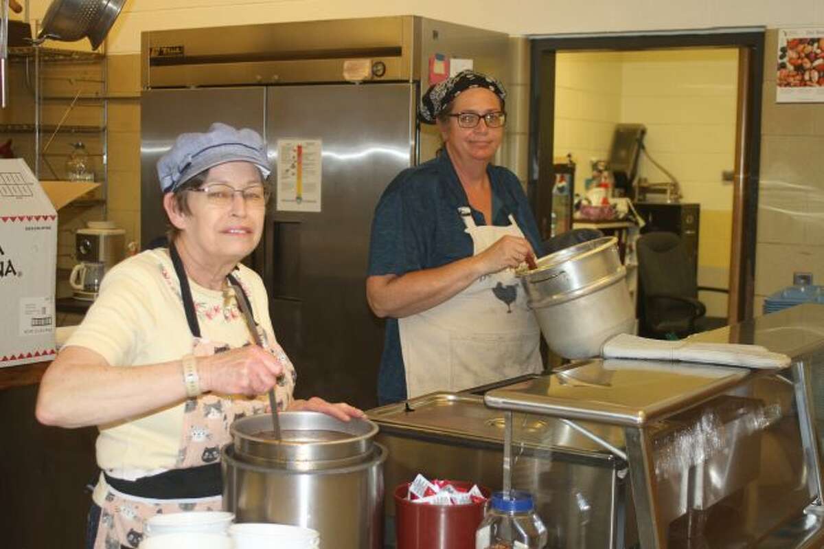 Food service director Ann Lind (right) and staff members prepare another tasty lunch for the Manistee Catholic Central students. Lind has been providing the students with a variety of new foods and entrees encouraging them to try new things.