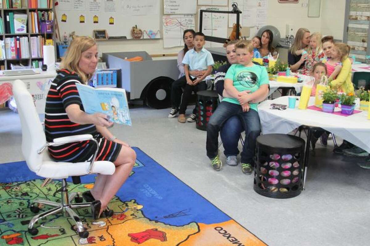 Bear Lake Schools principal Sarah Harless reads the book "I Will Love You Forever" to first grade students and their mothers at Thursday's Mother's Day and Tea in Ann Edmondson's class.
