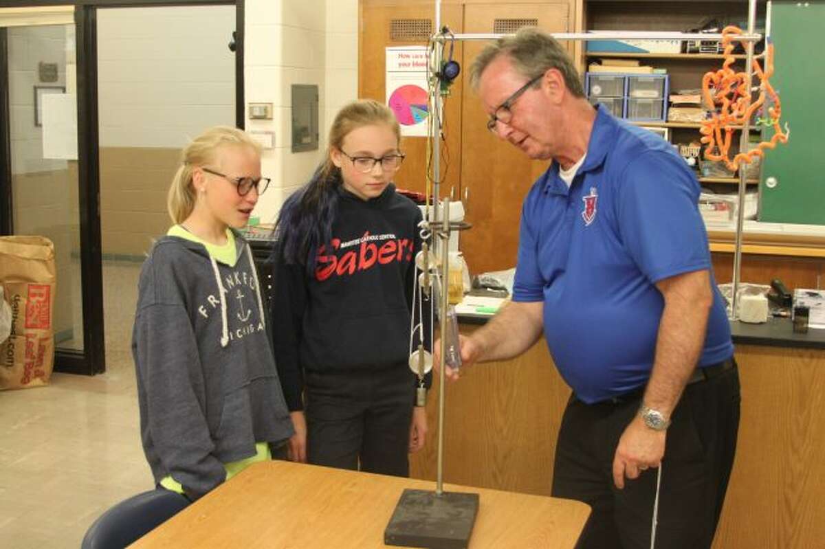 Being in the classroom as a science teacher was Ed Kolanowski's favorite part of his job at Manistee Catholic Central for the past 36 years. Kolanowski retired at the end of the school year, but kept right on teaching to the last moment as he is shown telling Grace Kidd and Elizabeth Logan how this science project works.