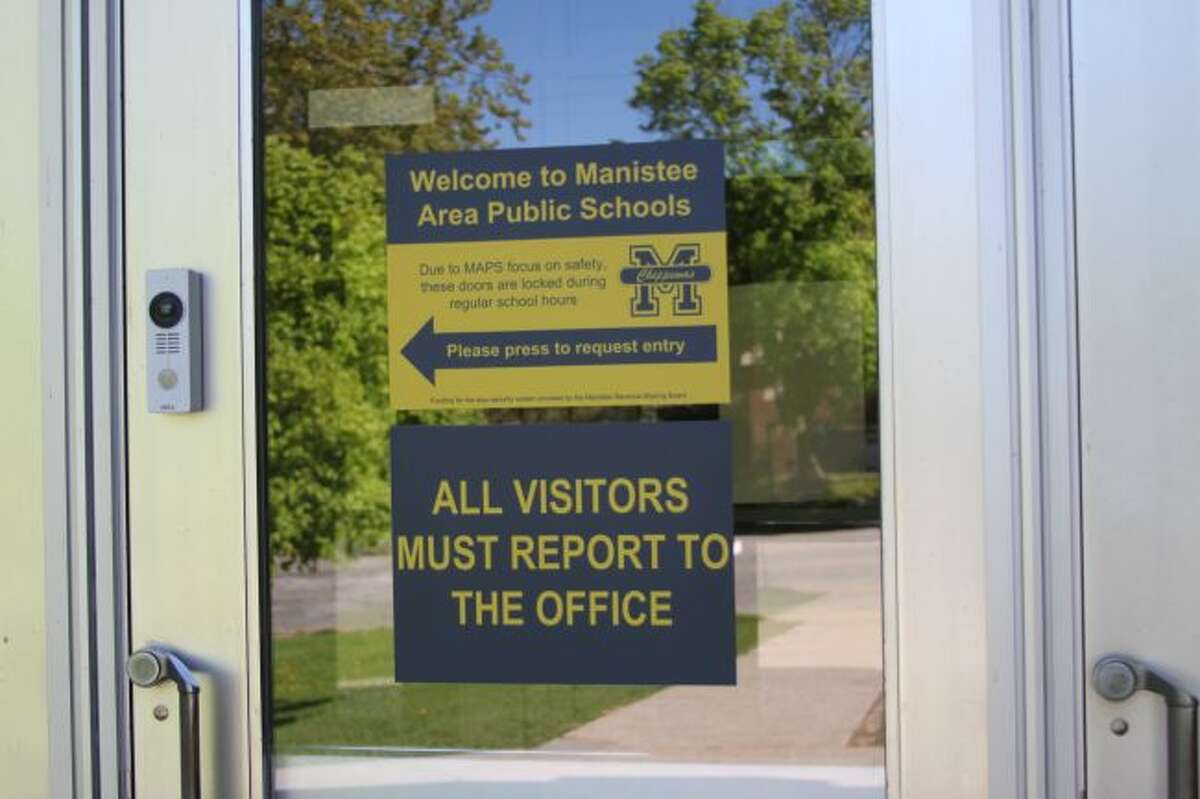 Signs like this one at Kennedy Elementary School show the buzzer system that visitors must use to gain access to the building. The Manistee Intermediate School District received a Manistee County Local Revenue Sharing grant to put these security measures in all the county schools.
