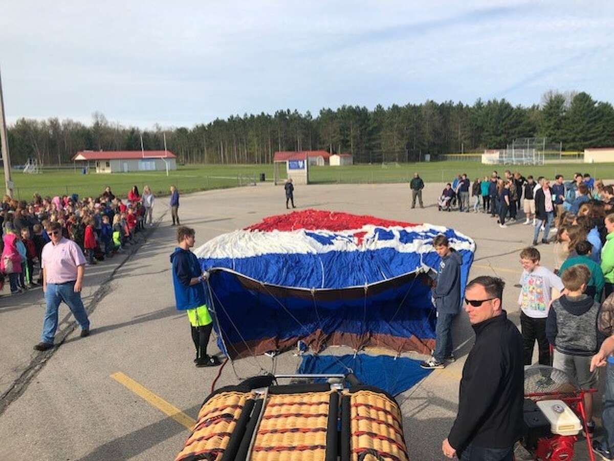 Students at Brethren Schools watch as the Remax Hot Air Balloon gets ready to be inflated. Several teachers had the opportunity to take a tethered ride in the balloon.