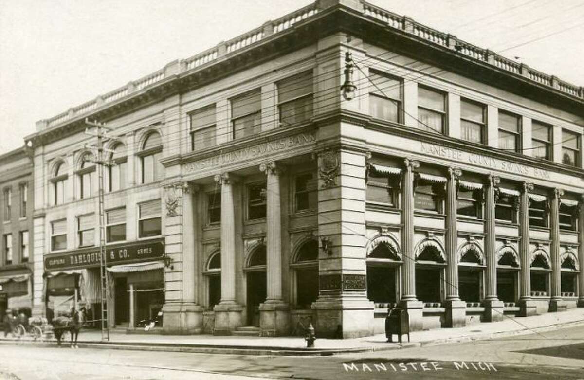 The Manistee County Savings Bank looked much the same in the early 1900s as it does today with the exception of some patrons arriving at the building in a horse and buggy.
